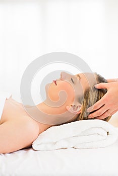 Relaxed Woman Receiving Head Massage At Health Spa