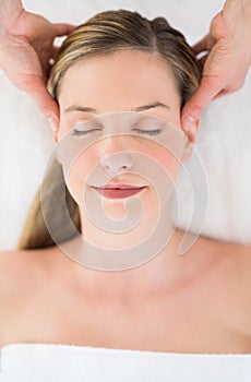 Relaxed Woman Receiving Head Massage At Health Spa