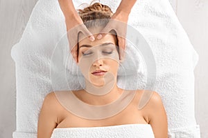 Relaxed woman receiving head massage