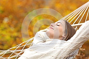 Relaxed woman resting on hammock in fall season