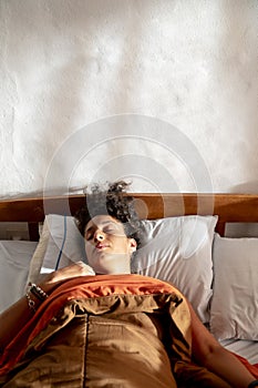 Relaxed woman sleeping in bed.