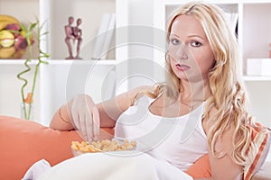 Relaxed woman with unhealthy snack