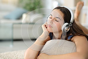 Relaxed woman wearing headphone listening chill music