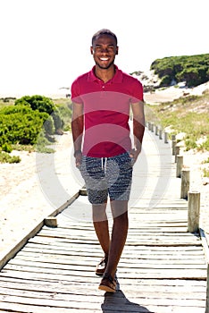 Relaxed young african man walking outdoors