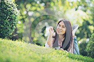 Relaxed Young Beautiful Woman With Smiling Face Enjoy Eating Pork Stick In The Park.