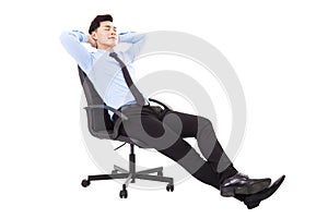 Relaxed Young businessman sitting in a chair isolated