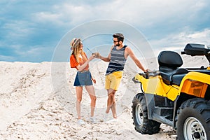 relaxed young couple with atv and coconut cocktails