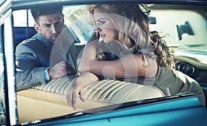 Relaxed young couple in the retro car