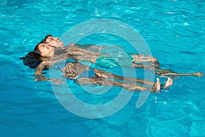 Relaxed young couple in swimming pool