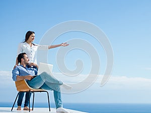 Relaxed young couple working on laptop computer at home