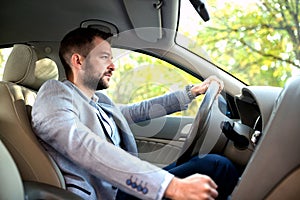 Relaxed young man driving his car