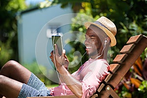 Relaxed young man using digital tablet