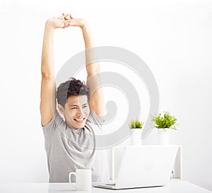 Relaxed young man watching laptop