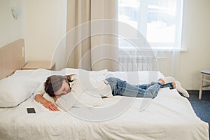 Relaxed young pretty woman sleeping in bed with blank screen mobile phone