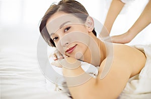 Relaxed Young woman enjoy massage in spa salon