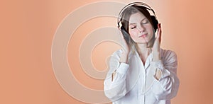 Relaxed young woman enjoying listening to music in wireless earphones, stress free meditation. Audiobook