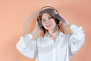 Relaxed young woman enjoying listening to music in wireless earphones, stress free meditation. Audiobook