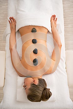 Relaxed young woman laying on massage table