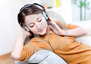 Relaxed young woman listening music photo