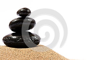 Relaxing on the beach, black stones on