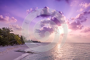 Relaxing and calm sea view and beach scene. Open ocean water and sunset sky and palm trees. Tranquil nature background