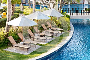 Relaxing chairs beside of swimming pool in residential garden
