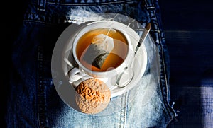 Relaxing chamomile tea. Cup mug hot tea and oat cookie. Mug filled tea close up. Herbal green or black whole leaf