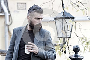 Relaxing coffee break. Hipster hold paper coffee cup and enjoy park environment. Drink it on the go. Man bearded hipster
