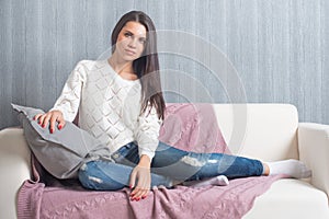Relaxing on couch, sofa at home, comfort. cute young woman smiling,