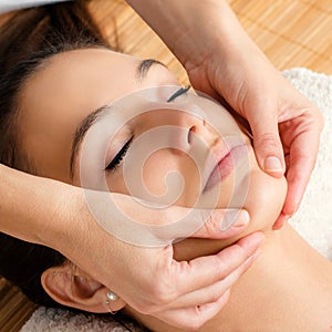 Relaxing facial massage on female chin. photo