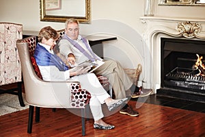 Relaxing by the fire. A senior couple relaxing by the fire while on vacation.