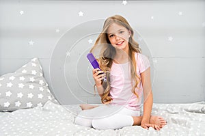 Relaxing hair brushing. Happy child hold hair brush. Brushing before and after bed. Haircare and styling. Untangling or