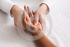 Relaxing hand massage for unrecognizable african lady