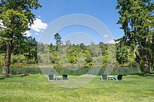 Relaxing loungers and outdoor tables beside Waikato River