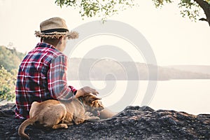 Relaxing moment Asian boy and dog in nature