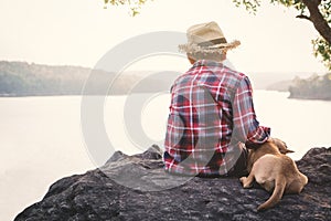 Relaxing moment Asian boy and dog in nature