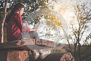 Relaxing moment Asian tourist reading a book on park