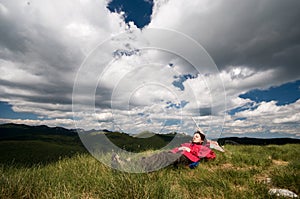 Relaxing on the mountain, under dramatic clouds