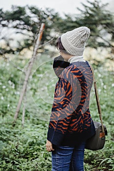 Relaxing in Nature : Young woman standing alone on the meadow