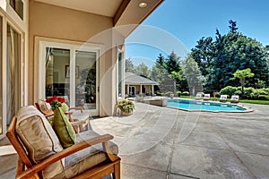 Relaxing outdoor seating arrangement overlooking swimming pool.