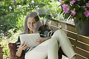 Relaxing outside reading a digital tablet