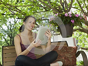 Relaxing outside reading a digital tablet