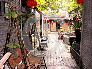 Relaxing and peaceful Chinese courtyard. Hanging red lanterns, plants and