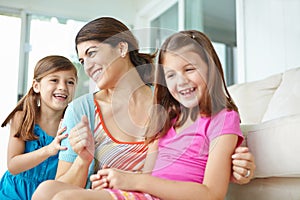 Relaxing on the porch together. A young mother spending some quality time with her two daughters on the porch.