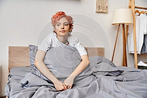 relaxing red haired queer person in