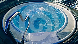 A Relaxing Soak in the Luxurious Hot Tub with a Stylish Metal Hand Rail