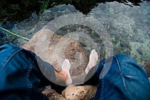 Relaxing by soaking feet in clear water.