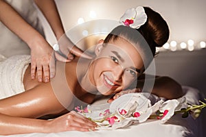 Relaxing In Spa Salon. Woman Enjoying Back Massage