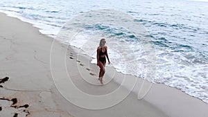 Relaxing summer holiday at the beach - cute girl at the ocean