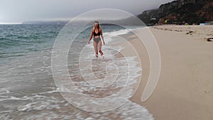 Relaxing summer holiday at the beach - cute girl at the ocean